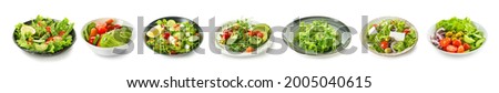 Plates with different healthy salads on white background