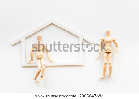 Family concept. Couple of wooden figures in house
