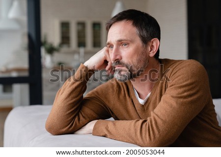 Bored tired sad mature middle-aged man depressed lonely having no visitors of his children. Divorce , bachelor , health problems concept. Lockdown, unemployment, needless man on social distance Royalty-Free Stock Photo #2005053044