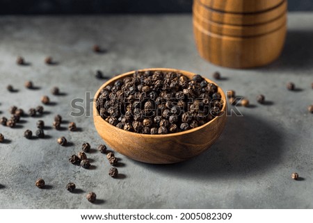 Raw Organic Black Peppercorns in a Bowl Royalty-Free Stock Photo #2005082309