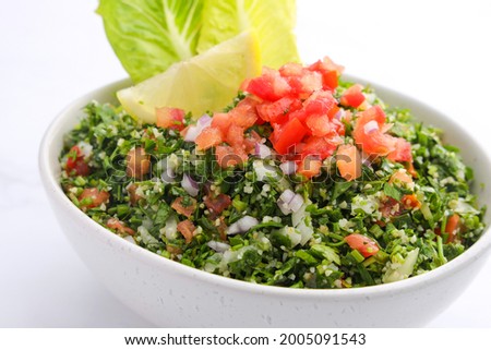 Traditional Arabic Salad Tabbouleh isolated on marble backdrop