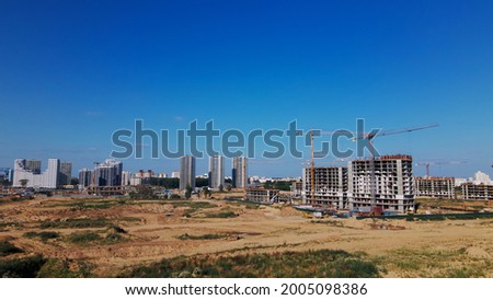 Modern urban development. Construction site with multi-storey buildings under construction. Construction of a new city block. Aerial photography.
