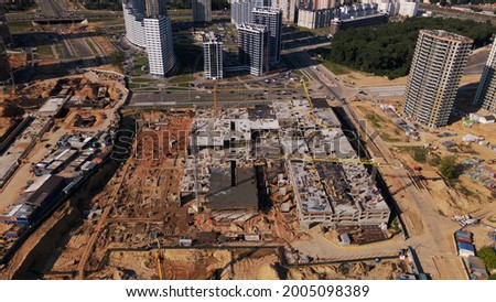 Modern urban development. Construction site with multi-storey buildings under construction. Construction of a new city block. Aerial photography.