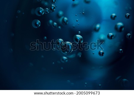 Abstract background of dark blue color bubbles in liquid. 