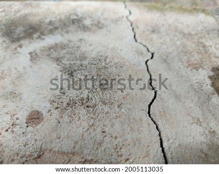 Grunge concrete cement wall with crack in industrial building, great for your design and texture backgrounds.