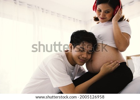 Handsome young husband and a beautiful wife, who are pregnant for about ุ6 months. He takes care of her closely with love and cherish, with hugs and gentle touch. Being maternity and parenthood