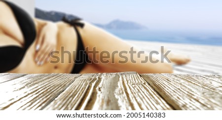 Desk of free space for your deocration and slim toung woman in bikini . Summer time. 