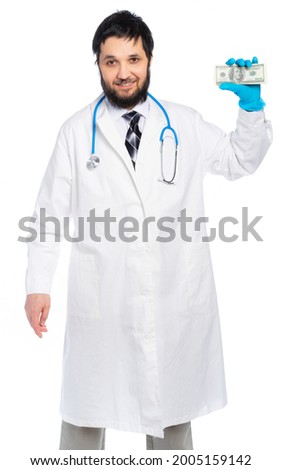 a medic in a white coat holds money and looks at us. isolated, white background