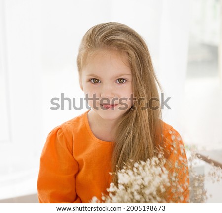 Portrait of a cute blonde, baby portrait, baby with flowers