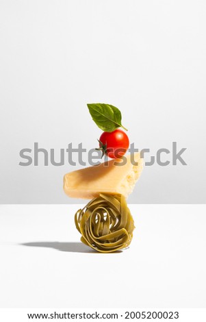 Creative still life with balancing food on white background