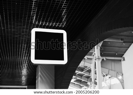 Black illuminated signboard. Shop or cafe sign design mock up on the ceiling in the shopping mall.