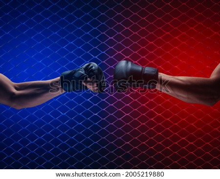 Mma fight, close up of two fists hitting each other over dark background