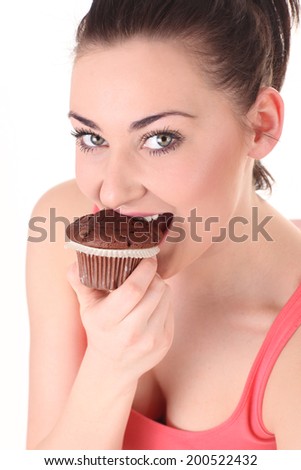  Young woman eating tasty chocolate cake on white background