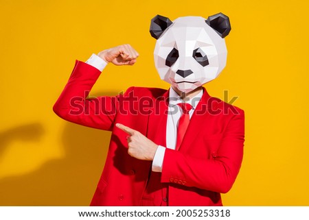 Photo of reliable strong guy direct finger bicep wear panda mask red tux isolated on yellow color background