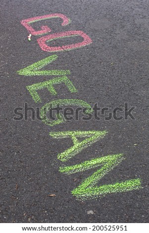 Words Go Vegan drawning on asphalt background. Healthy concept.