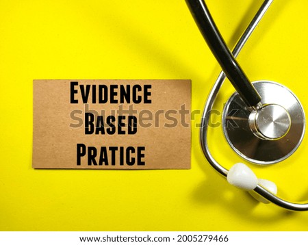Medical concept. Text EVIDENCE BASED PRATICE on brown card with stethoscope on yellow background.