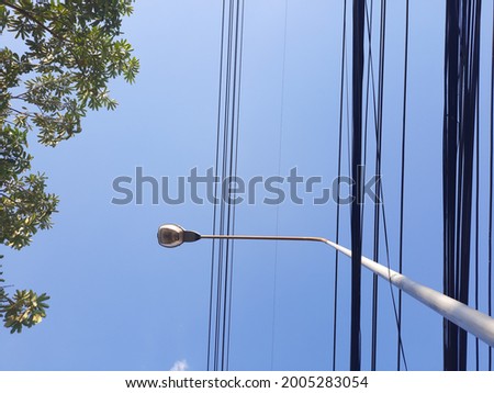 Electric pole and cable on the blue sky, light bulb, lamp