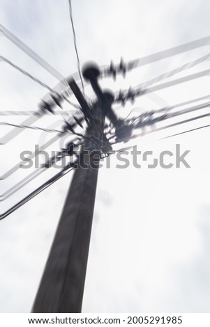 Defocused abstract background of electricity pole when sunny taken from a low angle