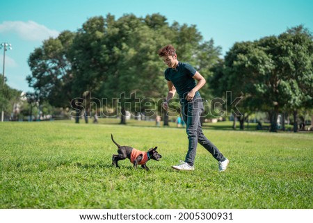 man adopt a puppy and takes the dog to the park. men and dogs, pets