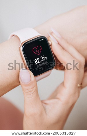Woman wearing a smartwatch mockup to check her heart rate Royalty-Free Stock Photo #2005315829