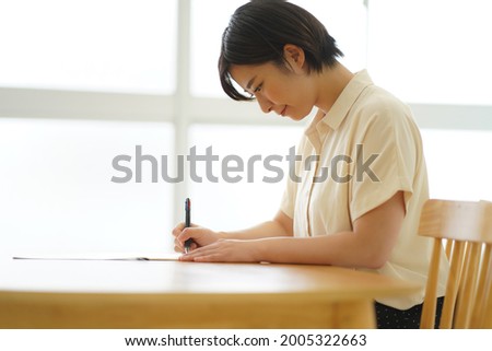 A woman practicing ballpoint pen writing 