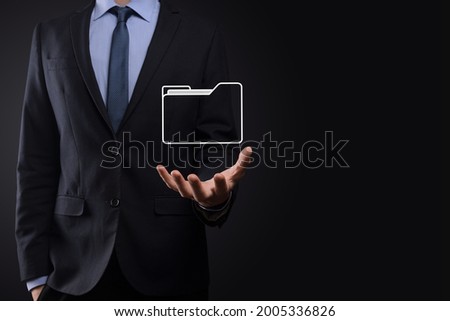 Businessman hold folder icon.Document Management System or DMS setup by IT consultant with modern computer are searching managing information and corporate files.Business processing