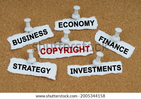 Business concept. On the table there are pieces of paper with the inscriptions - Business, Economics, Finance and COPYRIGHT