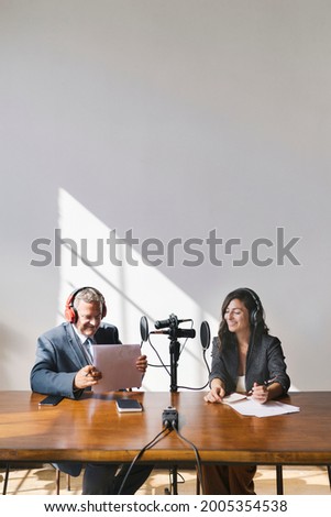 Female broadcaster interviewing her guest in a studio