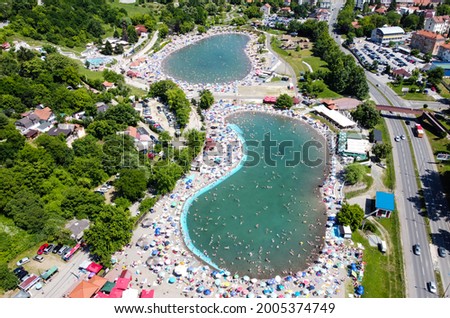 Pannonian Lakes Complex in Tuzla, Bosnia and Herzegovina. Aerial drone view of overcrowded open swimming pools during peak of tourist season. Tourist destination. Panonska jezera.