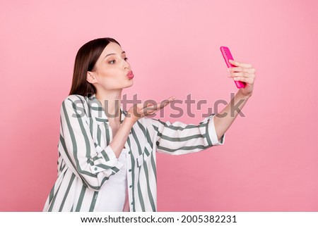 Profile side photo of young girl pouted lips send air kiss video call cellphone isolated over pastel color background