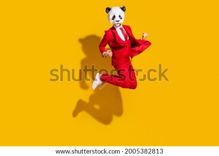 Photo of panda identity guy jump celebrate victory wear mask red tux shoes isolated on yellow color background