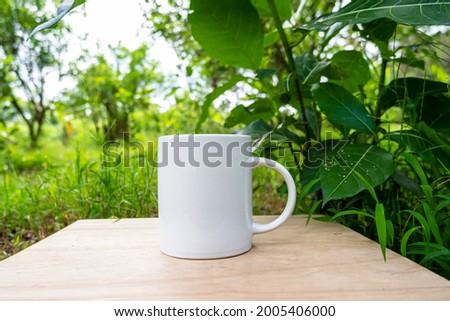 white mug on nature background. white mug mockup
