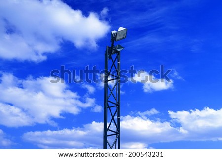 Image of a lamp post against a blue sky background