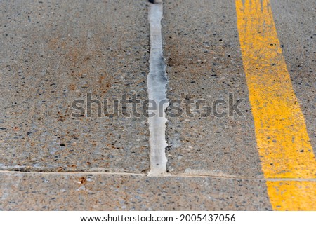 Cracks filled with silicon in a parking cement floor