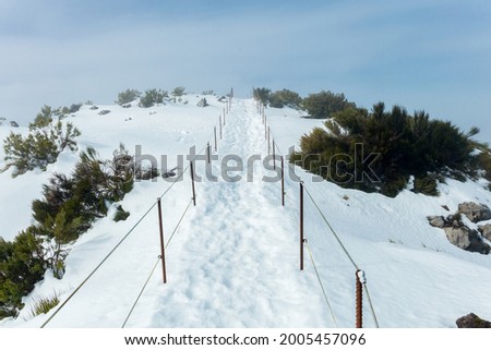 Overview of Pico Ruivo footpath covered with snow in Santana, Madeira island