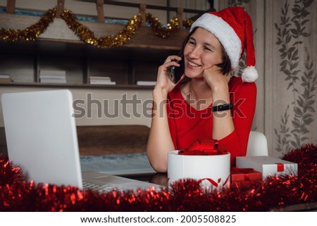 christmas, technology, people and online shopping concept. asian woman in santa helper hat with gift box, laptop computer and credit card over holidays lights background