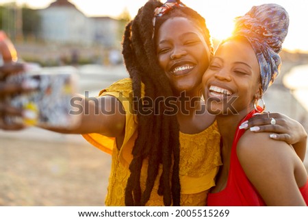 Happy girlfriends taking a selfie together outdoors
 Royalty-Free Stock Photo #2005515269