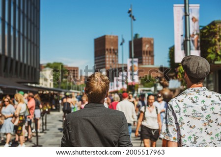 Summer holiday in a city. Two friends walking in Oslo. Royalty-Free Stock Photo #2005517963
