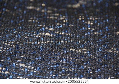 Dark blue woolen fabric with gold threads. Backgrounds