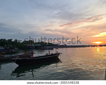 picture of a small boat with sunset