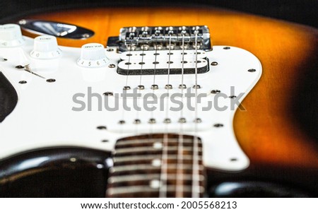 Close up of music guitar. Stringed electric musical instrument. Musical instrument for rock, blues, metal songs. Guitar strings, close up. Electric Bass Guitars. Electric guitar.