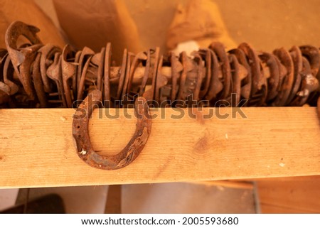 horseshoe metal sybol on wood shelf in farm