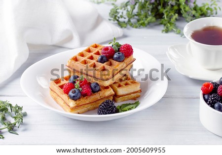 Viennese waffles, with berries, on a white table, breakfast, no people, horizontal, Royalty-Free Stock Photo #2005609955