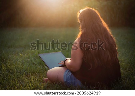 Business woman working from home outdoors nice day sunset, beautiful light. 