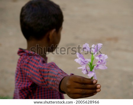 An asian kid giving flower, friendship concept image