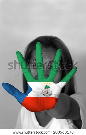 woman with her hands signaling to stop and Equatorial Guinea flag