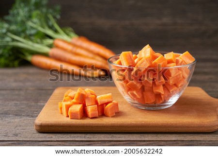 diced carrots on a wooden table, selective focus, rustic style.dice carrots. Royalty-Free Stock Photo #2005632242