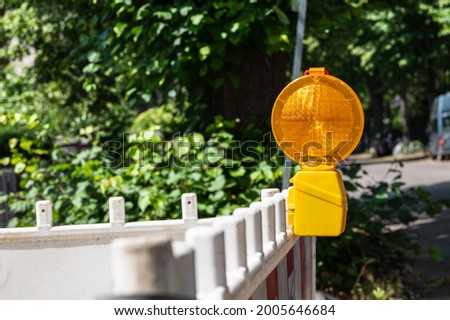 Orange hazard lights on a construction site barrier