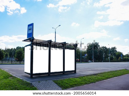 Bus stop with blank advertising board in summer day. Nobody. place for your outdoor advertising. 
Background for the advertising layout. street advertising. background for congratulations