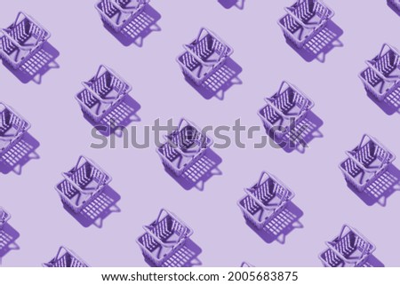 Pattern miniature shopping basket in a supermarket in purple tint. Minimalistic copy space shopping concept.